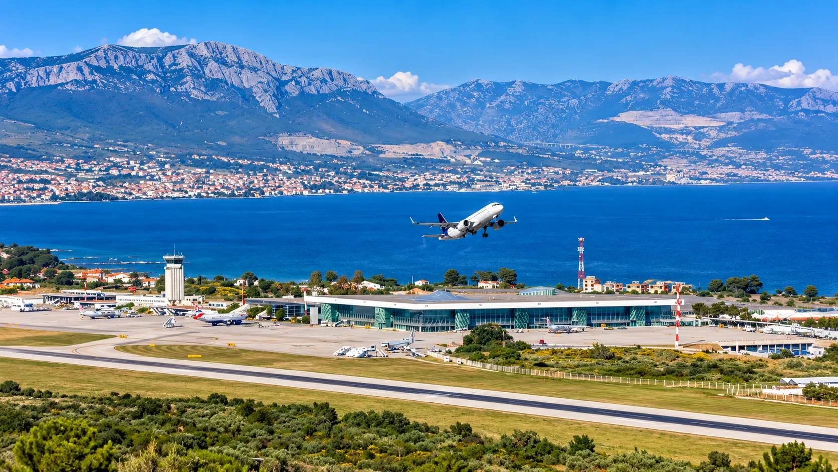 Split Airport terminal with an aircraft taking off over the Adriatic coast